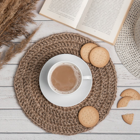Flatlay with cap of americano or espresso jute mat cookies and bookの写真素材