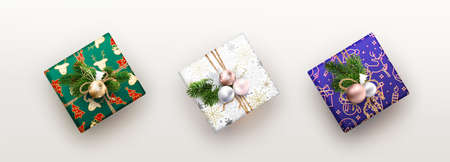 Three colored Christmas boxes with different decorations
