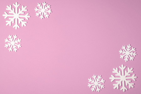 Christmas snowflake border frame on pink background. Christmas minimal texture with copy space. top view.の写真素材