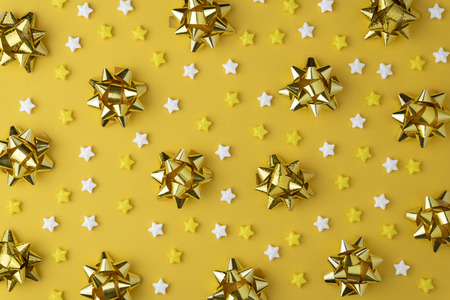 Christmas pattern with candy flat lay on yellow  background.
