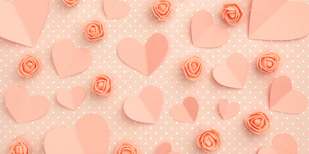 Valentines day floral coral composition. Love Day concept with coral flowers rose and heart flat lay...
