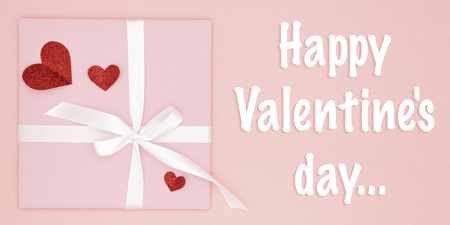 Happy Valentines Day greeting card decorated red heart and pink gift box flat lay on living coral...