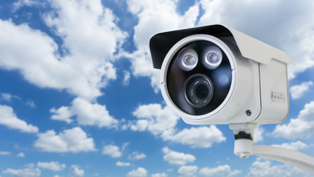 CCTV security camera on blue sky backgroundの写真素材