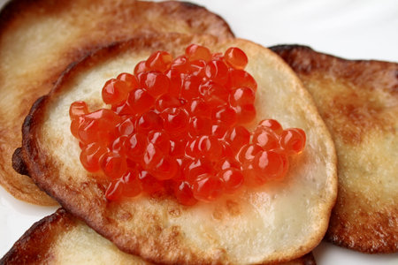 Fritters with red caviar on a plate.の写真素材