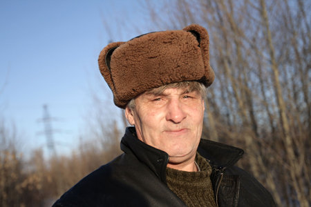 Portrait of the man in fur-cap in winterの写真素材