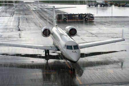 The airliner behind the window in a rainy day
