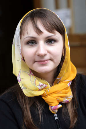 The brunette happy girl with orange kerchiefの写真素材