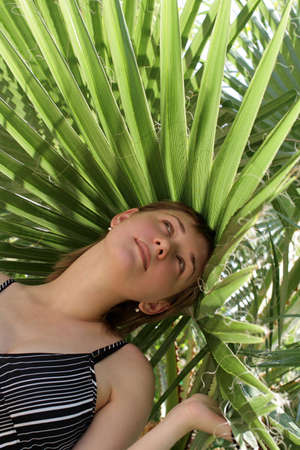 The girl poses in a botanical gardensの写真素材