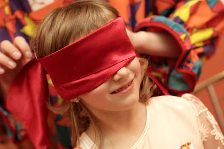 The girl plays hide-and-seek at homeの写真素材