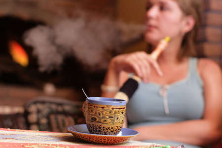 The girl smokes hookah in a turkish cafeの写真素材