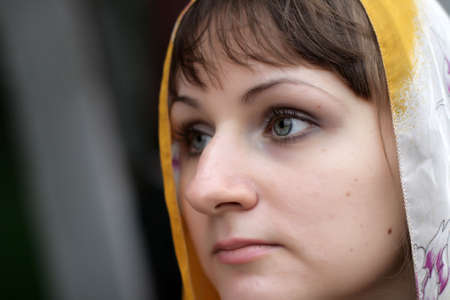Portrait of serious brunette girl in kerchiefの写真素材