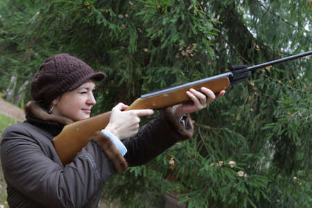 The woman aiming a pneumatic air rifle