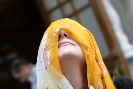 The girl poses with yellow headscarf outdoor