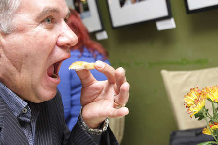 The hungry man with snack in cafe