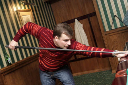The man playing in billiards in evening