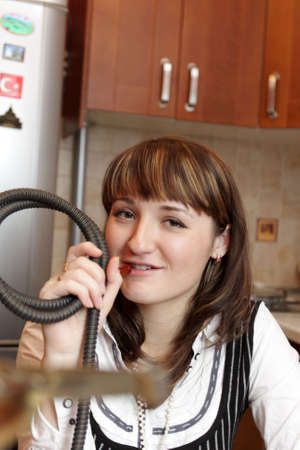 The smiling smoking girl relaxes at home