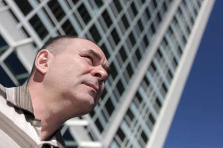 Portrait of man on a skyscraper backgroundの写真素材