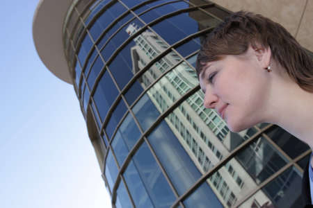 Portrait of a woman on a skyscraper backgroundの写真素材