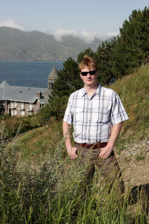The man poses on monastery background in Armenia