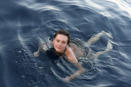The swimming girl on Red sea in the evening