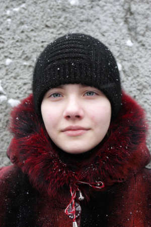 Portrait of teen on a grey wall background