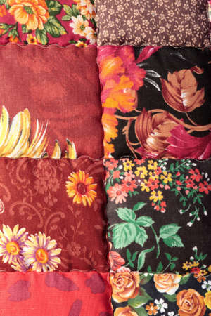 The red patchwork quilt in market as backgroundの写真素材