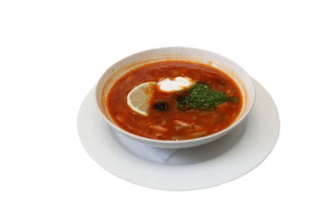 The soup plate with solyanka isolated on white. Solyanka is a thick, spicy and sour soup in the Russian and Ukrainian cuisine.の写真素材