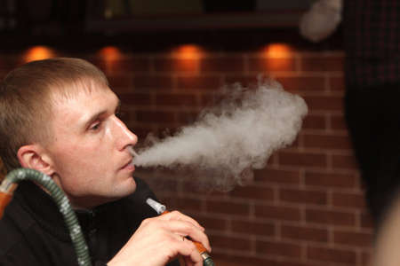 The man resting with shisha at hookah house