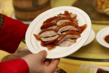 Peking Duck as main dish. Peking Roast Duck is a famous duck dish from Beijing that has been prepared since the imperial era, and is now considered one of China's national foods.の写真素材