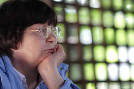 Portrait of pensive mature woman at summer houseの写真素材