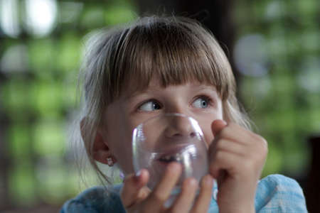 The teen drinks water at summer houseの写真素材
