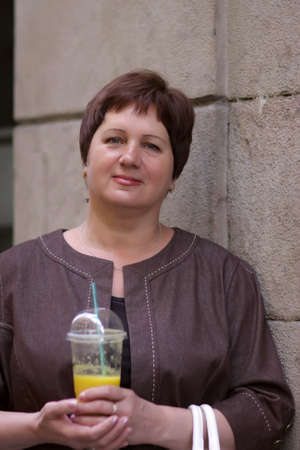 Mature woman withs orange juice at Gothic quarter in Barcelonaの写真素材