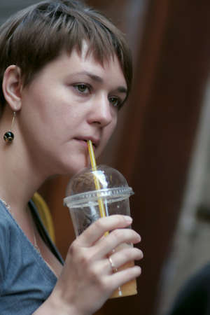 Woman drinks orange juice at Gothic quarter in Barcelonaの写真素材