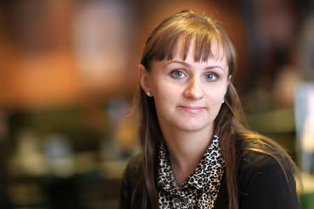 The happy russian young woman poses indoor
