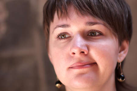 Portrait of sceptical woman on a brown backgroundの写真素材