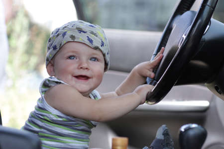 The happy baby poses in a carの写真素材
