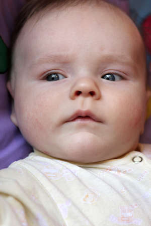 Portrait of serious little baby at home