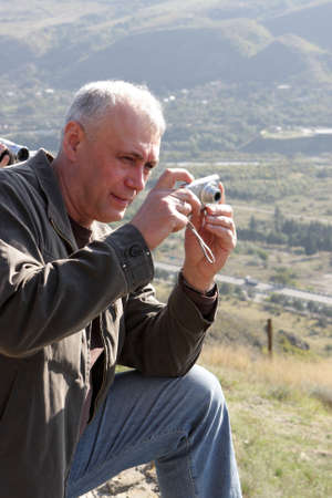 The tourist takes a picture of landscape in Georgia