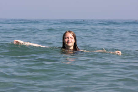The happy teen rests in the Mediterranean seaの写真素材