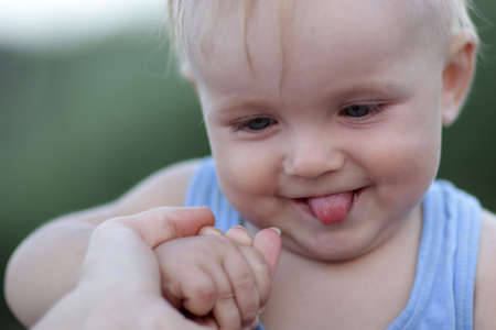 Portrait of baby with his tongue hanging out