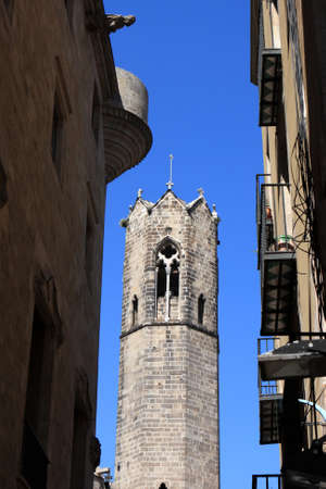 Cathedral between buildings at gothic quarter of Barcelonaの写真素材
