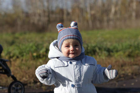 Happy little boy poses in the parkの写真素材