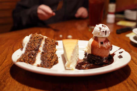 It is dessert from carrot cake, cheesecake and ice creamの写真素材