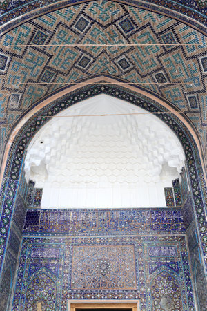 Decorated arch of Tilya Kori Madrasah from courtyard in Samarkand, Uzbekistanのeditorial素材