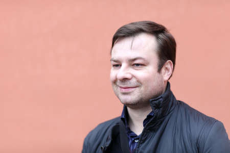 Portrait of smiling man on the red background
