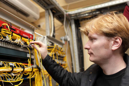 The technician connecting optical connector at the server room