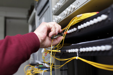 IT technician connecting ODF with telecom equipmentのeditorial素材