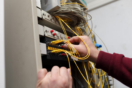 A technician attaching optical connector to ODF at a server roomのeditorial素材