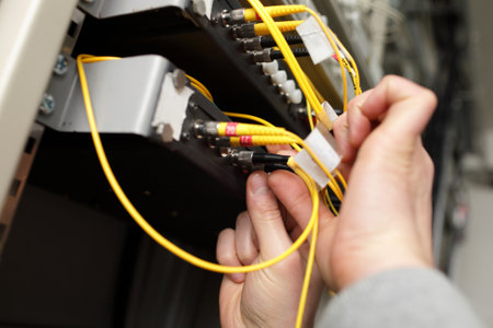 A technician with optical connector at telecom siteのeditorial素材