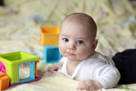 Portrait of funny baby on a bed at home